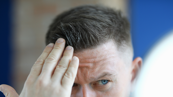 Man applying balm to hair